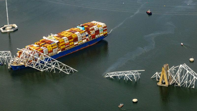 In an aerial view, the cargo ship Dali sits in the water after running into and collapsing the Francis Scott Key Bridge on March 26, 2024 in Baltimore, Maryland. 