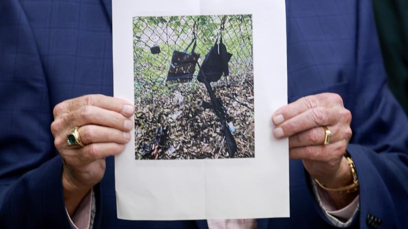 Palm Beach County Sheriff Ric Bradshaw holds a photograph of the rifle and other items found near where a suspect was discovered during a press conference regarding an apparent assassination attempt of former President Donald Trump on September 15, 2024 in West Palm Beach, Florida.