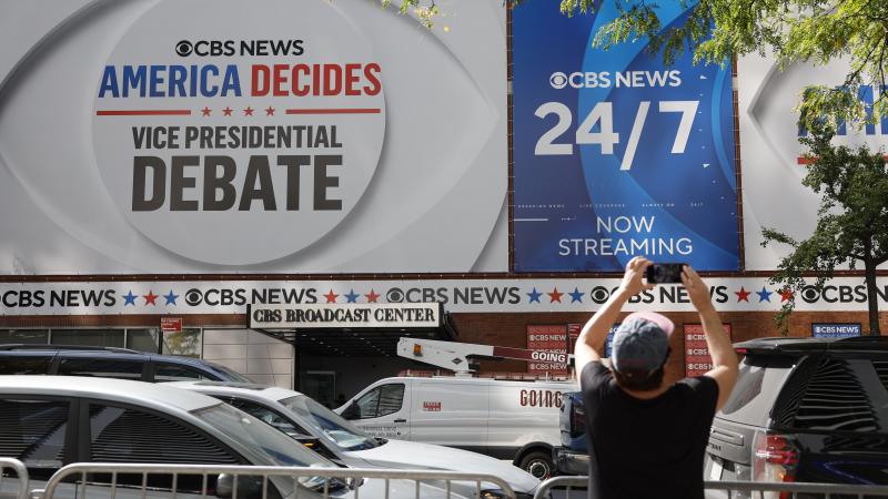 A woman takes pictures of the CBS Broadcast Center the day before the television network will host the vice presidential debate on September 30, 2024 in New York City.