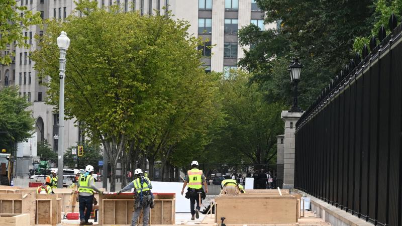 Construction workers setup inauguration stands in front of the White House in Washington, DC on October 4, 2024. 