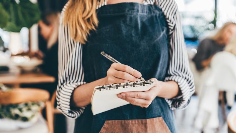 Waitress Writing On Notepad
