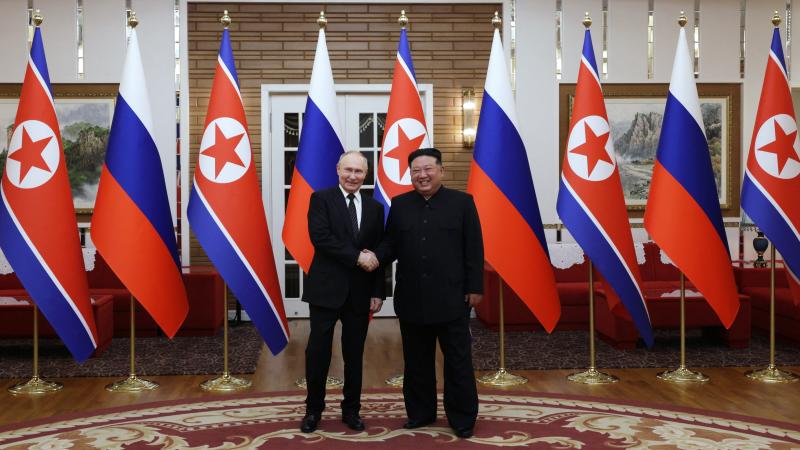 Russia's President Vladimir Putin (L) shakes hands with North Korea's leader Kim Jong Un during a meeting in Pyongyang on June 19, 2024.