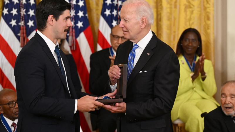 US President Joe Biden posthumously awards the nation's highest civilian honor, the Presidential Medal of Freedom, to Richard Trumka as Richard Trumka Jr. accepts, during a ceremony honoring 17 recipients, in the East Room of the White House in Washington, DC, July 7, 2022.