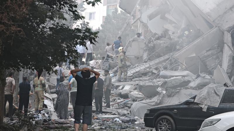 People look over damage to buildings in Nobonyad Square following Israeli airstrikes on June 13, 2025 in Tehran, Iran.
