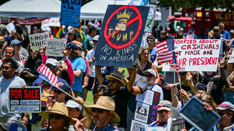 Demonstrators hold signs
