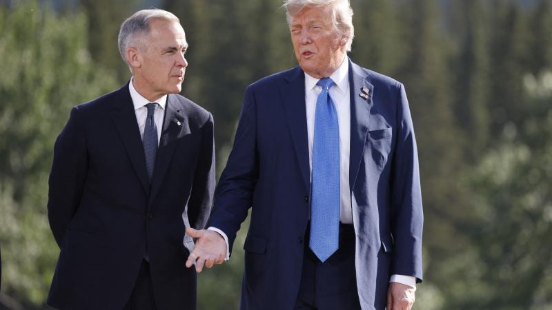 Canadian Prime Minister Mark Carney and US President Donald Trump pose for a family photo during the Group of Seven (G7) Summit at the Kananaskis Country Golf Course in Kananaskis, Alberta, Canada on June 16, 2025.