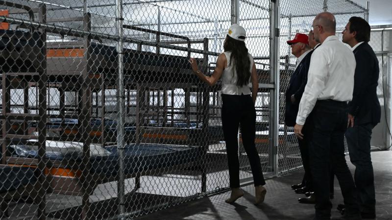 US President President Donald Trump and Homeland Security Secretary Kristi Noem visit a migrant detention center, dubbed "Alligator Alcatraz," located at the site of the Dade-Collier Training and Transition Airport in Ochopee, Florida on July 1, 2025.