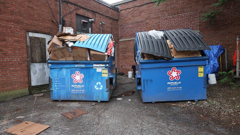 Over-flowing dumpsters behind Johnny's Luncheonette as a result of the impacts of the strike against waste collection company Republic Services on July 10, 2025.