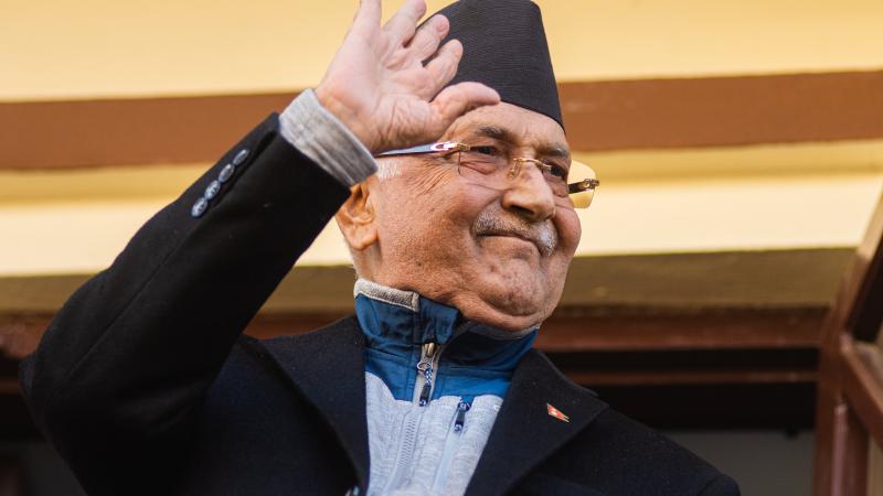 Khadga Prasad Sharma Oli (L) chairman of CPN(UML) party gestures from a balcony after reaching power-sharing deal with newly appointed coalition Prime Minister of Nepal Pushpa Kamal Dahal at Balkot, Nepal on Sunday, December 25, 2022