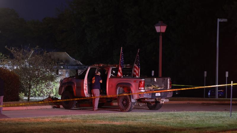 An FBI Evidence Response Team agent inspects the suspect's truck outside the Church of Jesus Christ of Latter-day Saints in Grand Blanc, Michigan, on September 28, 2025