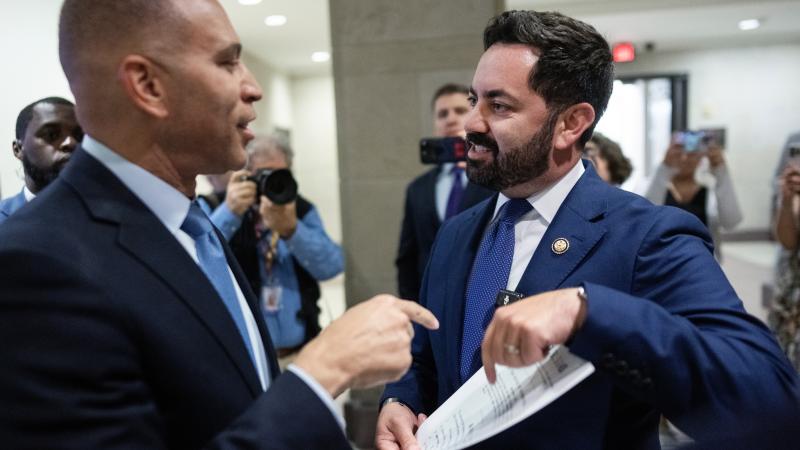 Rep. Mike Lawler, R-N.Y., right, confronts House Minority Leader Hakeem Jeffries, D-N.Y., about signing on to a bill that would extend Affordable Care Act tax credits, after a House Democrats news conference in the Capitol Visitor Center on Wednesday, October 8, 2025