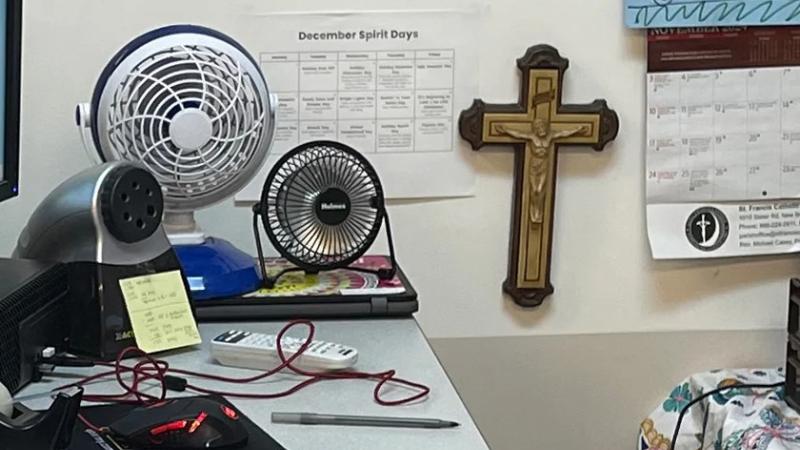 Marisol Arroyo-Castro's desk area has a crucifix