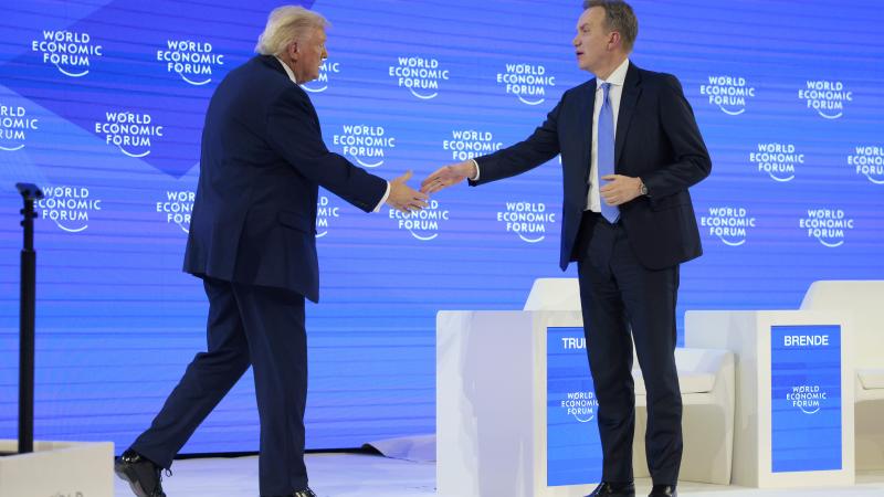 U.S. President Donald Trump is greeted by CEO of the World Economic Forum Børge Brende before taking part in a discussion onstage at the World Economic Forum (WEF) on January 21, 2026 in Davos, Switzerland