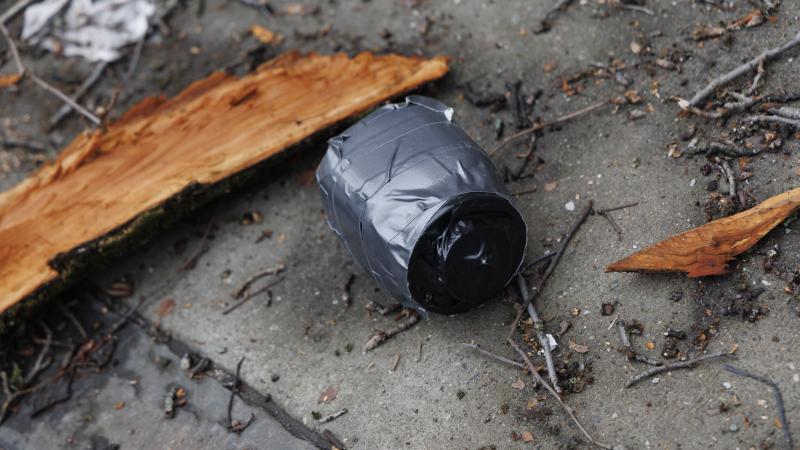 A homemade explosive device is seen on the ground after a left-wing protester throws the device at a demonstration held by far-right influencer Jake Lang outside Gracie Mansion in New York City, United States, on March 7, 2025.