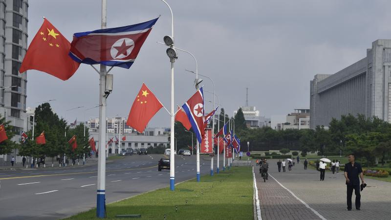TOPSHOT - The national flags of North Korea and China are displayed on a street in Pyongyang on June 8, 2026. Chinese President Xi Jinping arrived in Pyongyang on June 8, state news agency Xinhua reported, for his first official visit to North Korea since 2019. (Photo by KIM Won Jin / AFP via Getty Images)