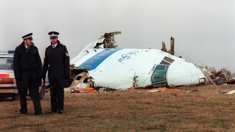 Policemen stand near the wreckage of the 747 Pan Am airliner that exploded and crashed over Lockerbie, Scotland, 22 December 1988. 