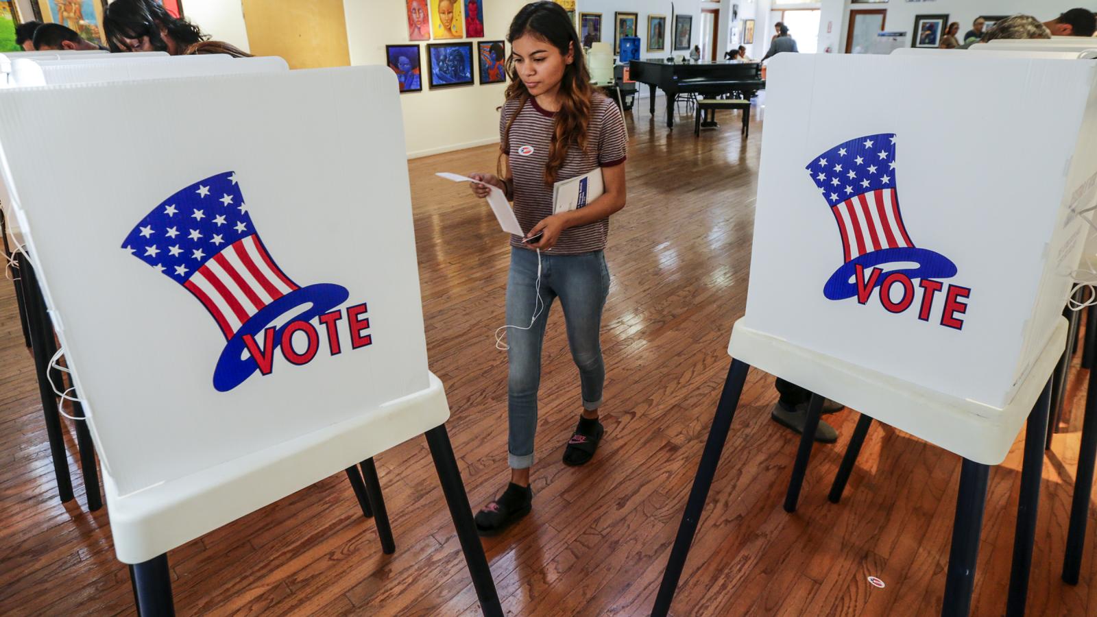 Maryjane Medina, 18, a first time voter, walks up to polling booth to cast her vote at a polling station set-up at Watts Towers Arts Center on November 8, 2016 in Los Angeles, California.