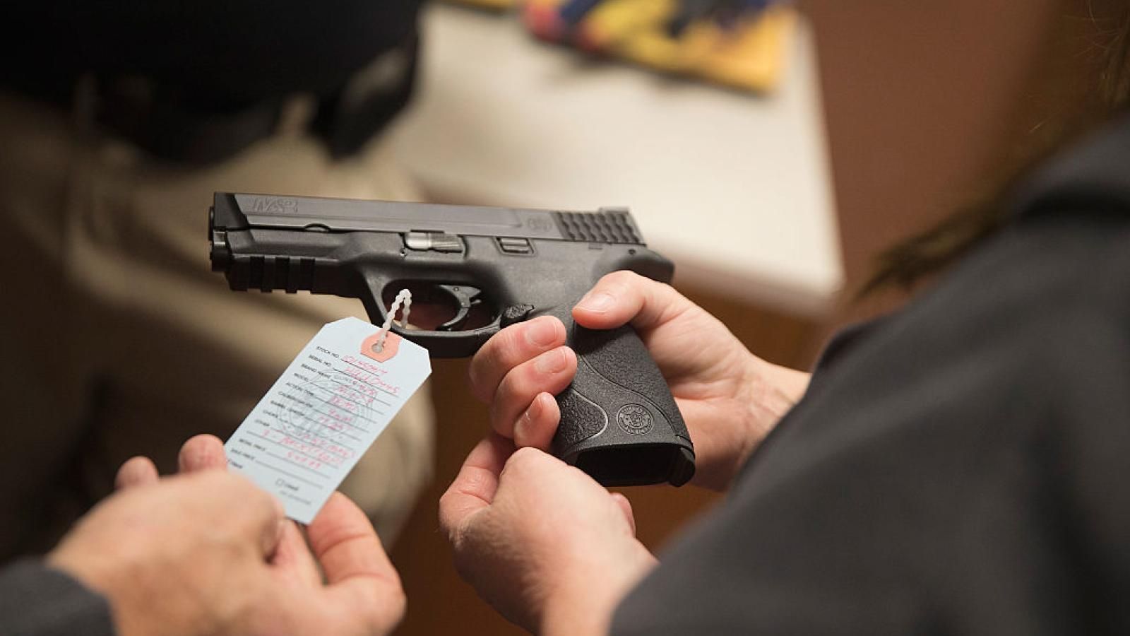 Customers shop for hand gun at Metro Shooting Supplies in Bridgeton, Missouri in 2014