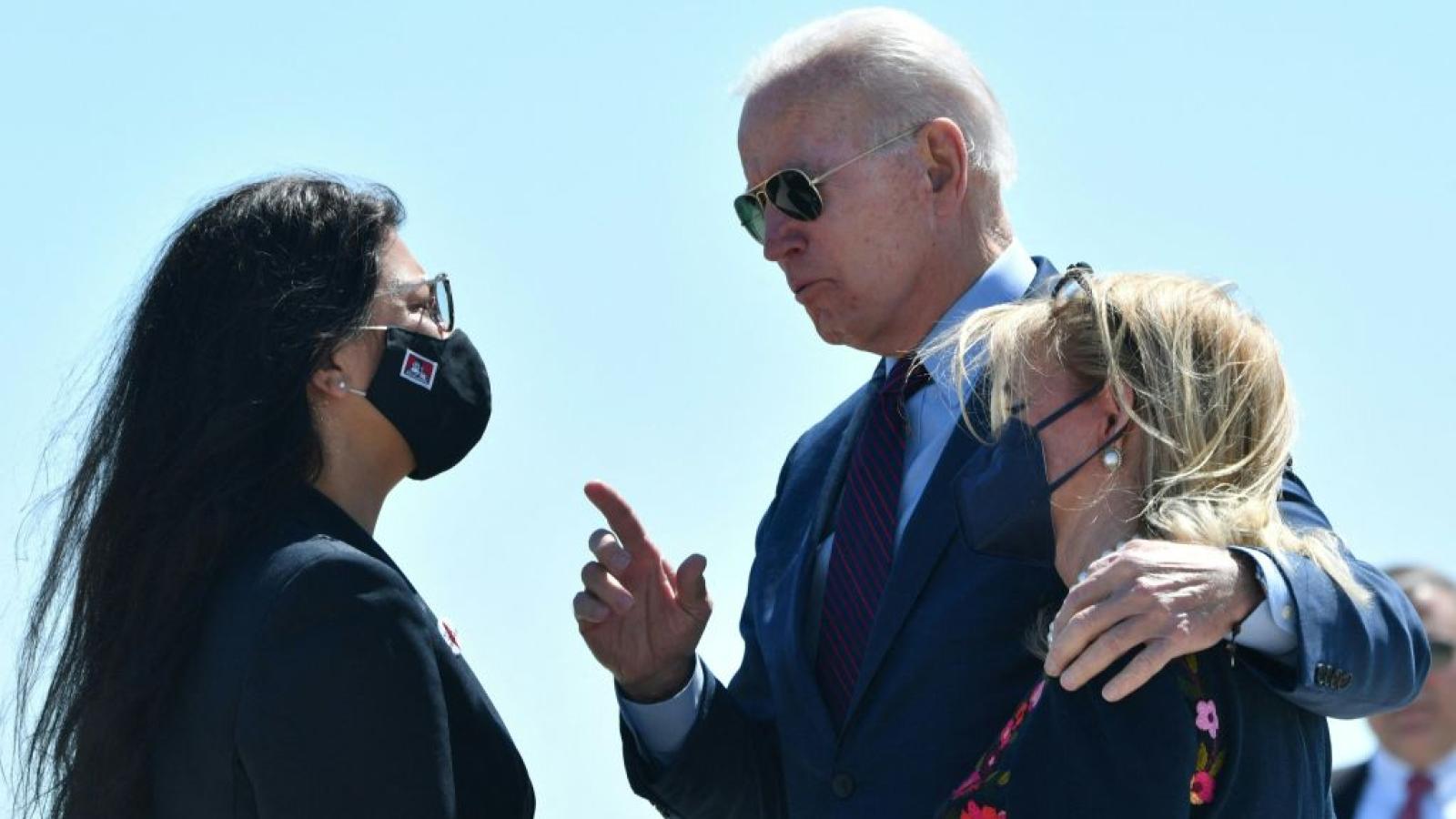 President Joe Biden with his arm around Rep. Debbie Dingell as he talks to Rep. Rashida Tlaib on May 18, 2021