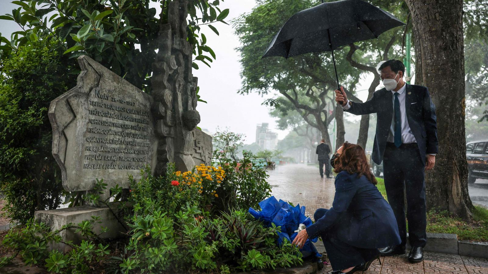 US Vice President Kamala Harris lays flowers at the Senator John McCain memorial site, where his Navy aircraft was shot down by the North Vietnamese, on the three-year anniversary of his death, in Hanoi on August 25, 2021.
