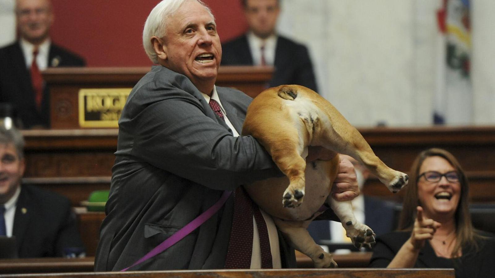 West Virginia Gov. Jim Justice hold up his dog during State of the State speech
