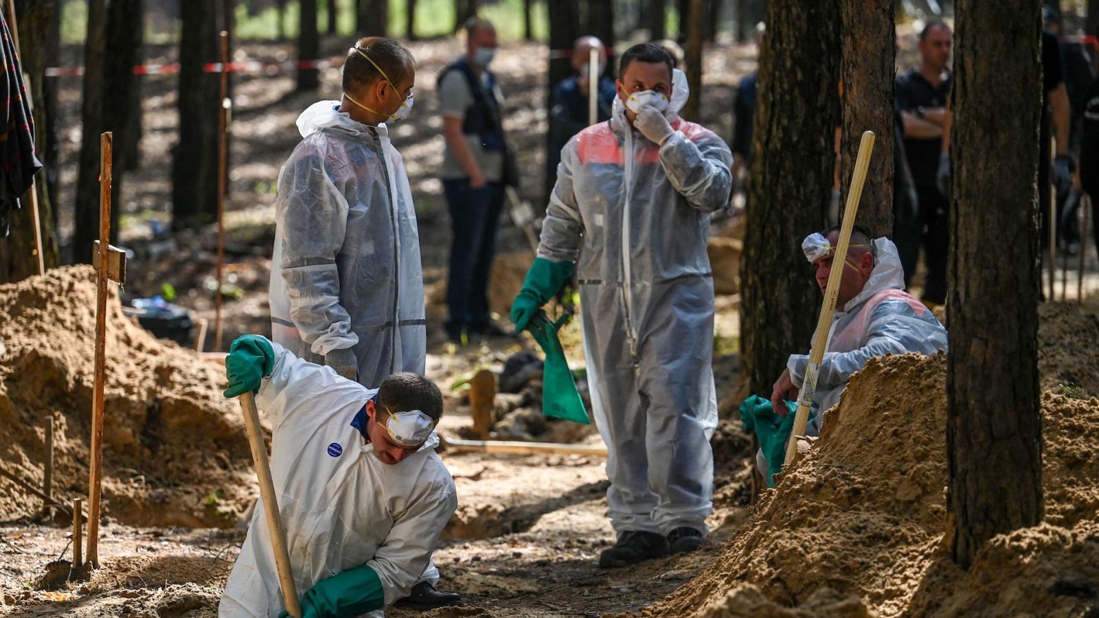 Forensic technicians at mass grave, Ukraine, Sept. 18, 2022