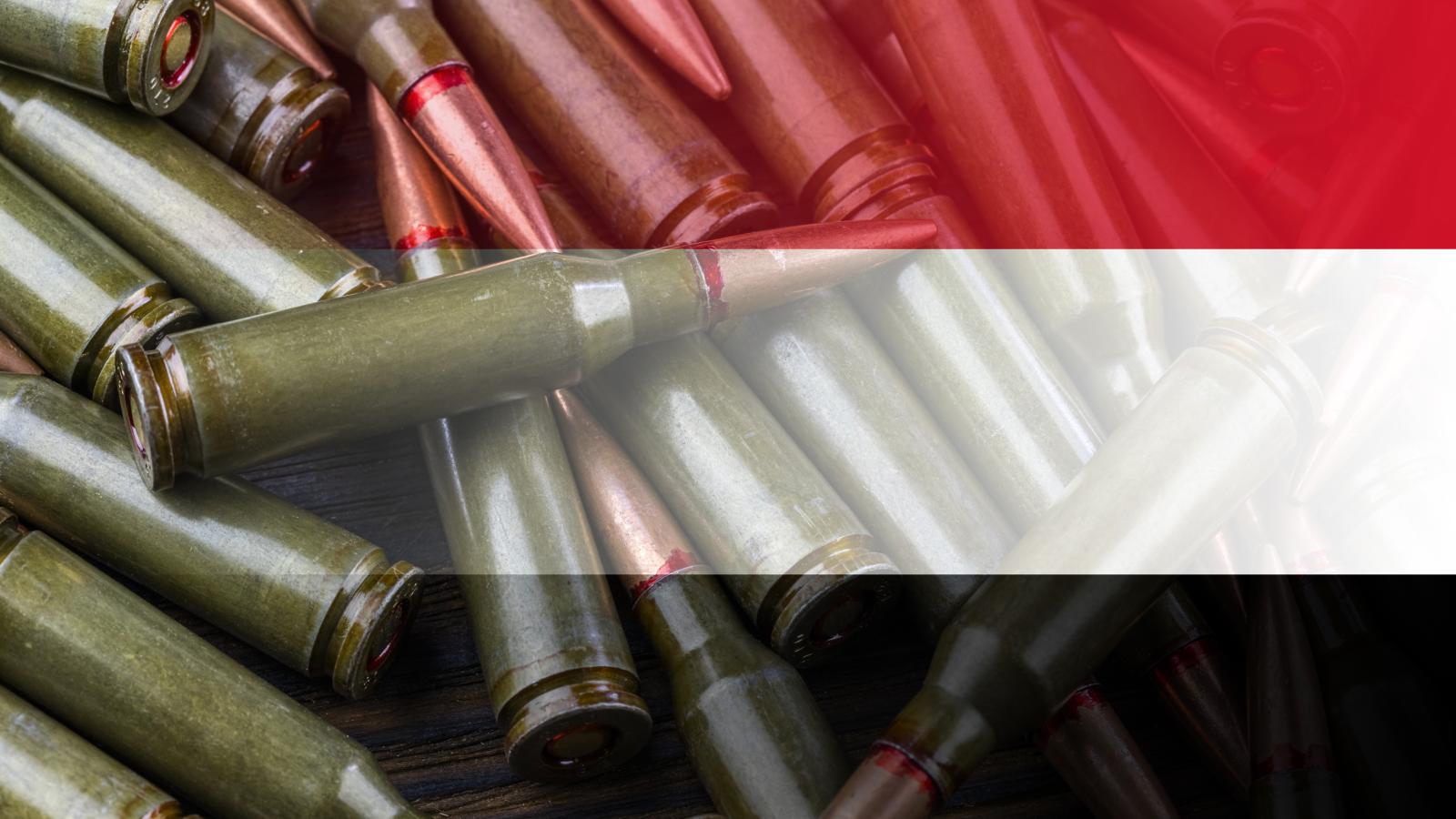Yemen flag on the background of machine gun cartridges