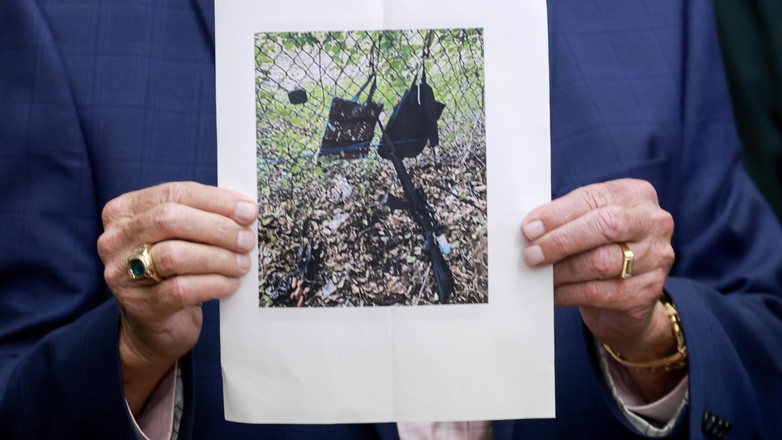 Palm Beach County Sheriff Ric Bradshaw holds a photograph of the rifle and other items found near where a suspect was discovered during a press conference regarding an apparent assassination attempt of former President Donald Trump on September 15, 2024 in West Palm Beach, Florida.