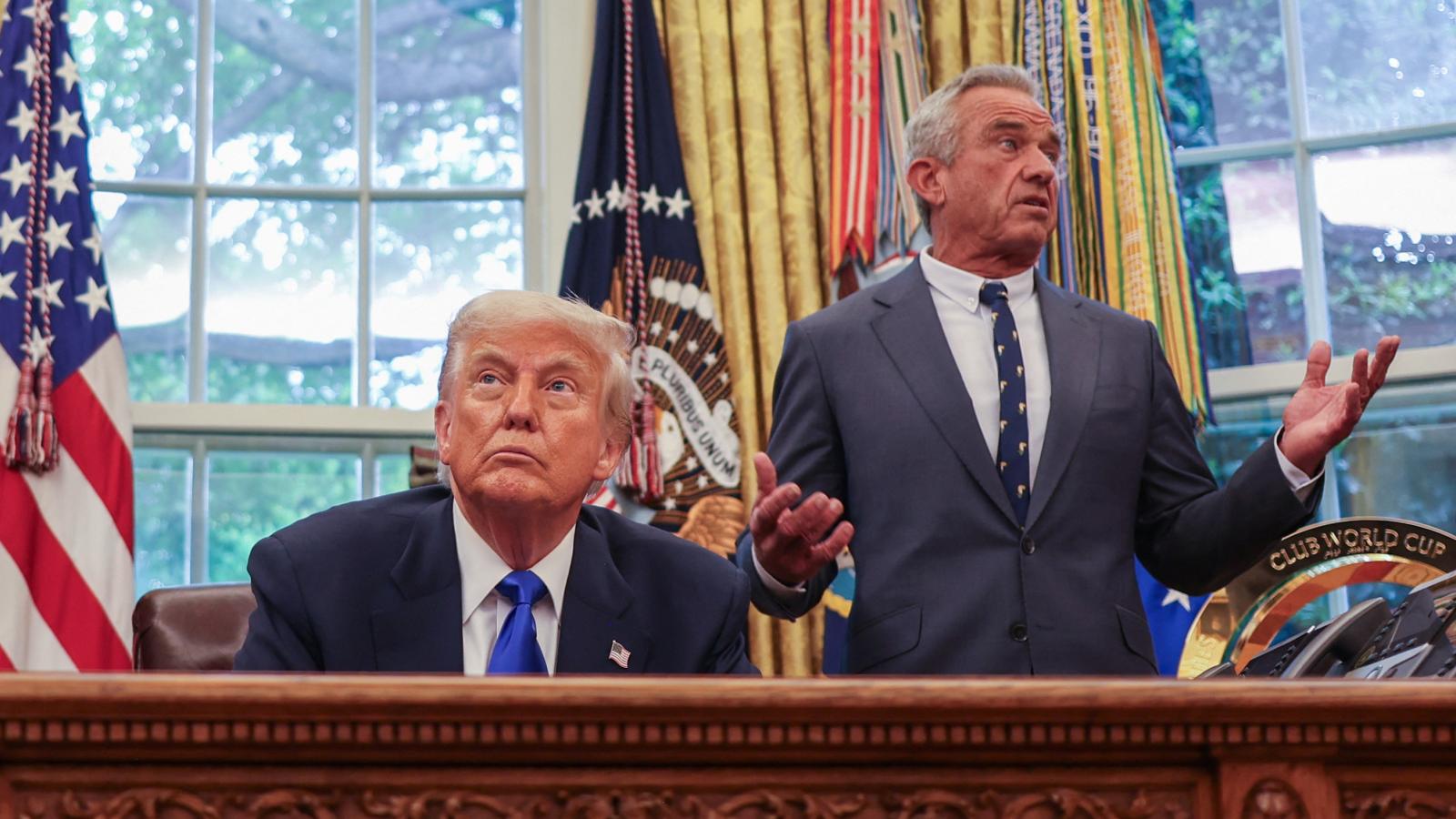 US Secretary of Health and Human Services Robert F. Kennedy Jr. (R) speaks US President Donald Trump during an executive orders signing event in the Oval Office of the White House in Washington, DC, on May 5, 2025. 