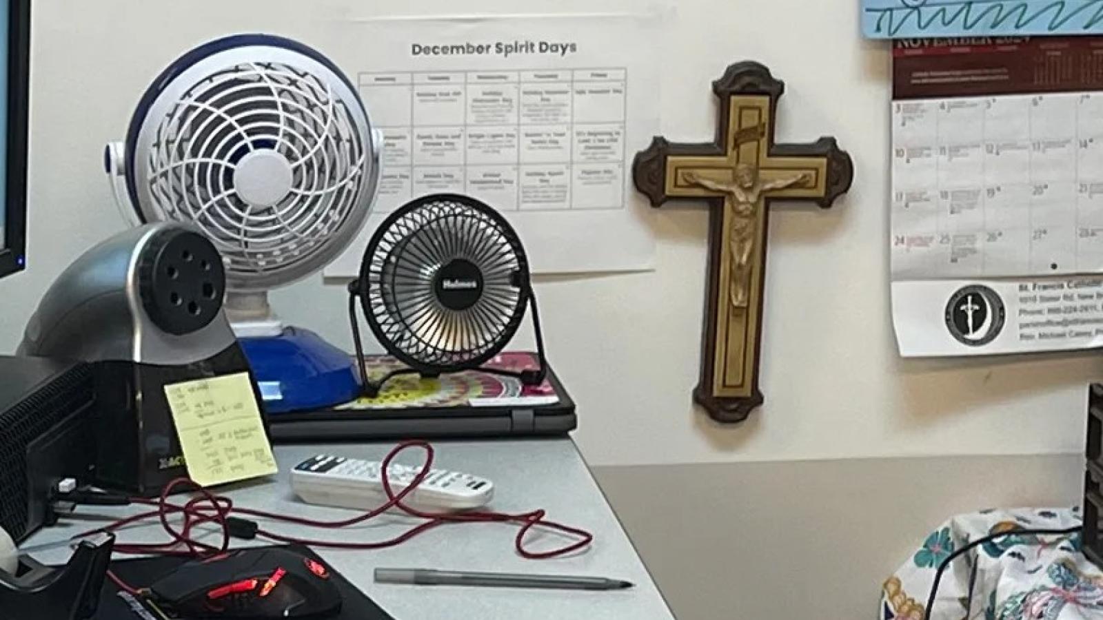 Marisol Arroyo-Castro's desk area has a crucifix