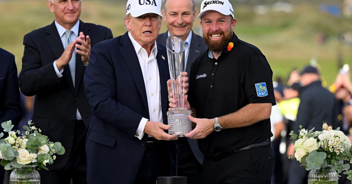 Photo: justthenews.com President Donald Trump (C,R) presents the winner's trophy to Ireland's Shane Lowry (C,R) on the final day of the Irish Open