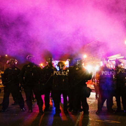 Police officers stand outside 4th District Police Station amid protests