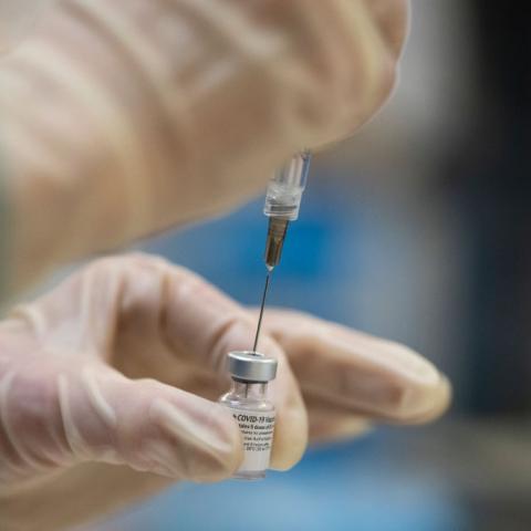 Healthcare worker preparing COVID-19 vaccine doses in Oregon on Dec. 16, 2020
