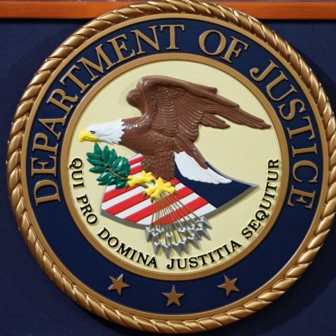 DOJ seal on a lecturn in 2018