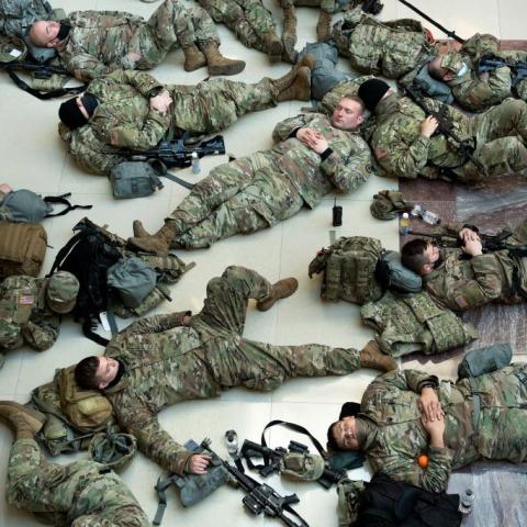 National Guard soldiers sleep on the marble floor inside the Capitol