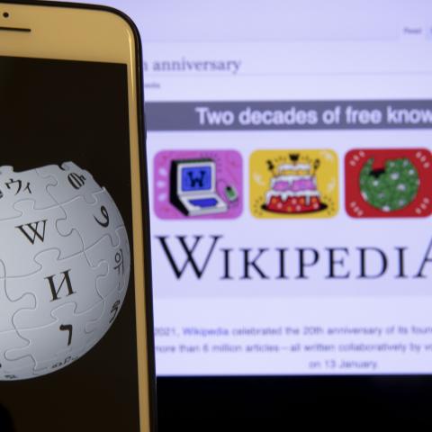 In this illustration photo Wikipedia logo is displayed on a smartphone as Wikipedia website is seen behind, in Ankara, Turkey on January 19, 2021. 