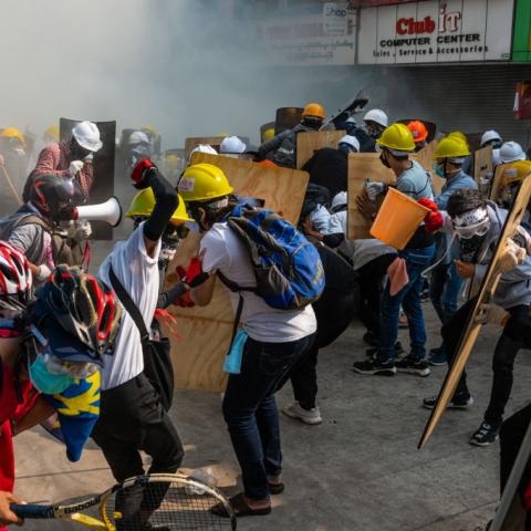 Protestors defend themselves in clashes with riot police in Myanmar on Feb. 28, 2021