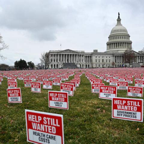 Signs calling for more relief, a second Paycheck Protection Program, and support from elected officials 
