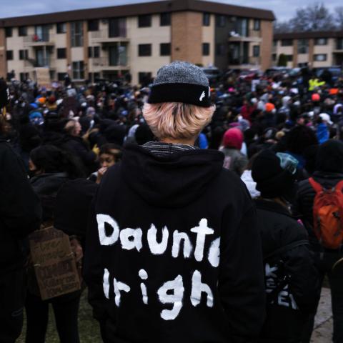 A person wears a hoodie bearing the name of Daunte Wright as protesters gather outside the Brooklyn Center police headquarters