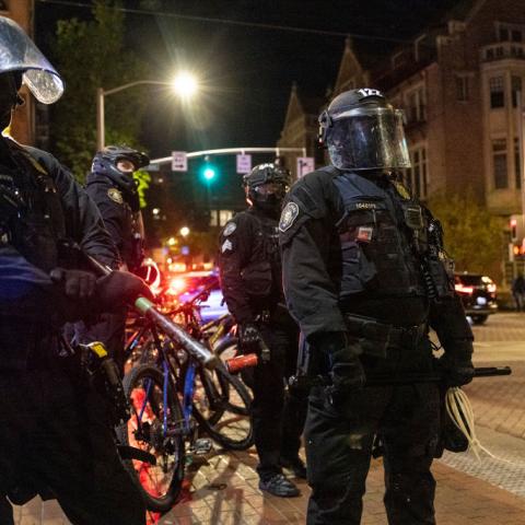  Portland police stand guard as tensions rise with a small group of protesters on April 20, 2021.