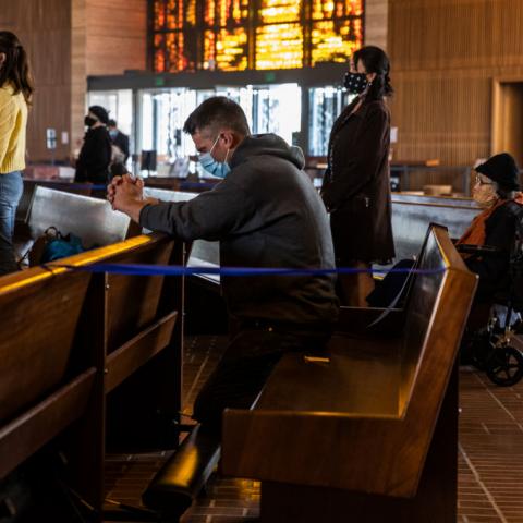 Keith Bergquist prays during an in-church Easter Mass celebration at Cathedral of Saint Mary of the Assumption in San Francisco, California 
