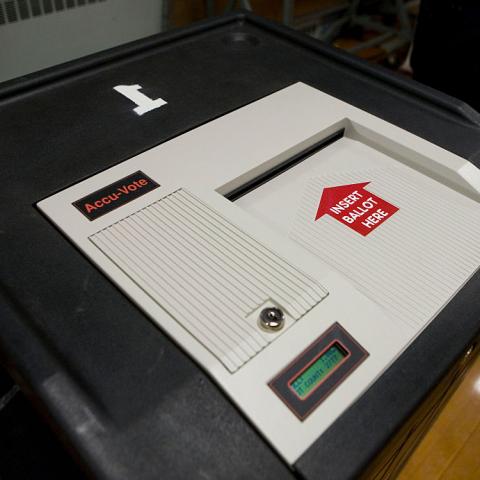 An AccuVote electronic scanning machine is used for counting the votes in New Hampshire