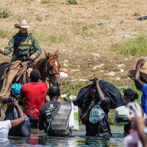  A United States Border Patrol agent on horseback uses the reins as he tries to stop Haitian migrants from entering an encampment on the banks of the Rio Grande near the Acuna Del Rio International Bridge in Del Rio, Texas on September 19, 2021.