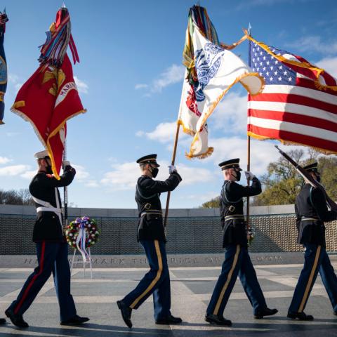 : A military honor guard arrives at the World War II Memorial for a wreath-laying ceremony to mark National Pearl Harbor Remembrance Day on December 7